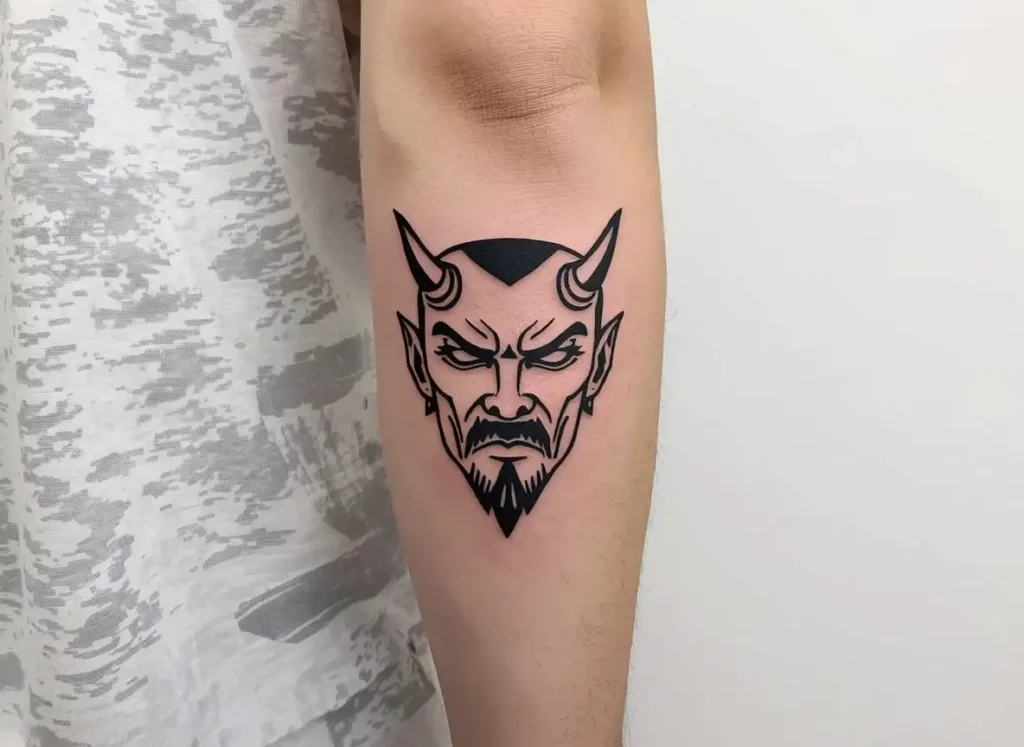Minimal demon face forearm tattoo men